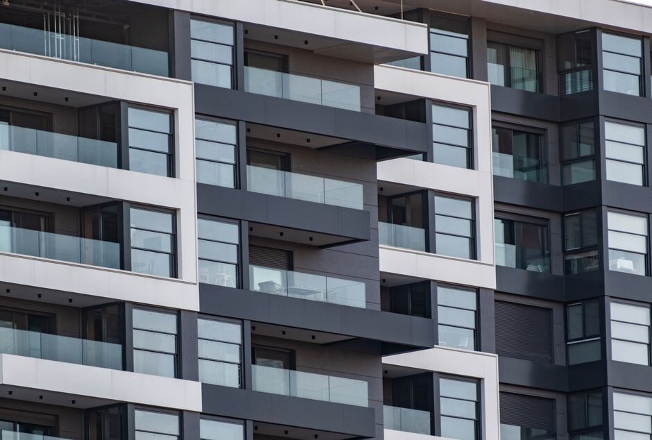 Contemporary apartment building with stacked glass balconies
