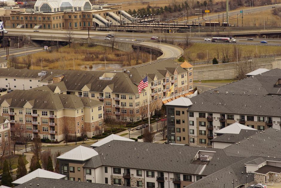 Aerial view of a new apartment community beside a highway interchange