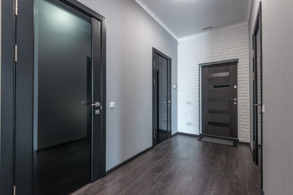Interior apartment corridor lined with unit doors