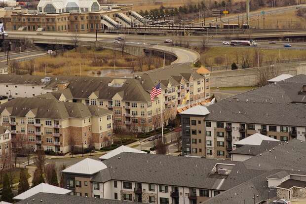 Aerial view of a new apartment community beside a highway interchange