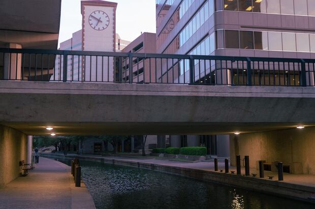 River channel passing beneath a terraced downtown San Antonio building