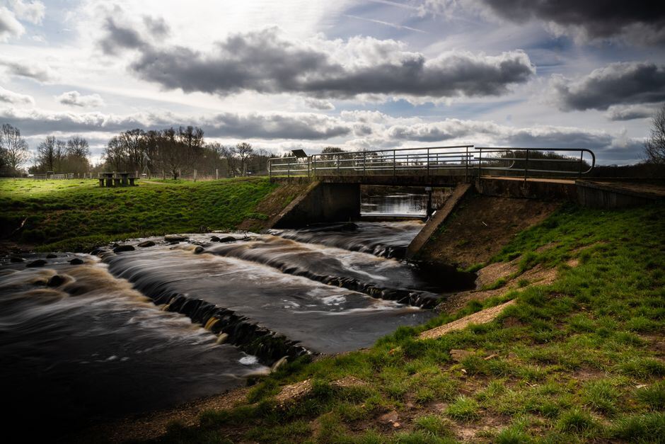 Low-water crossing over a shallow creek under storm clouds