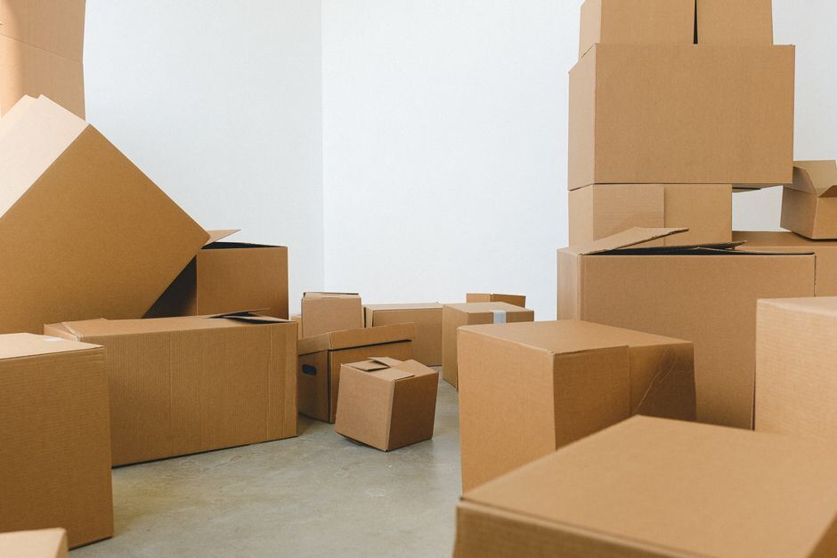 Stacked cardboard moving boxes in an empty room